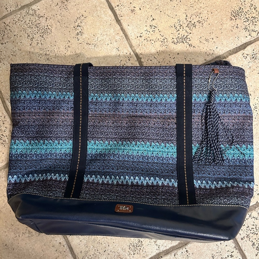 Expansive tote in blue fabric printed to resemble The Sak's crochet